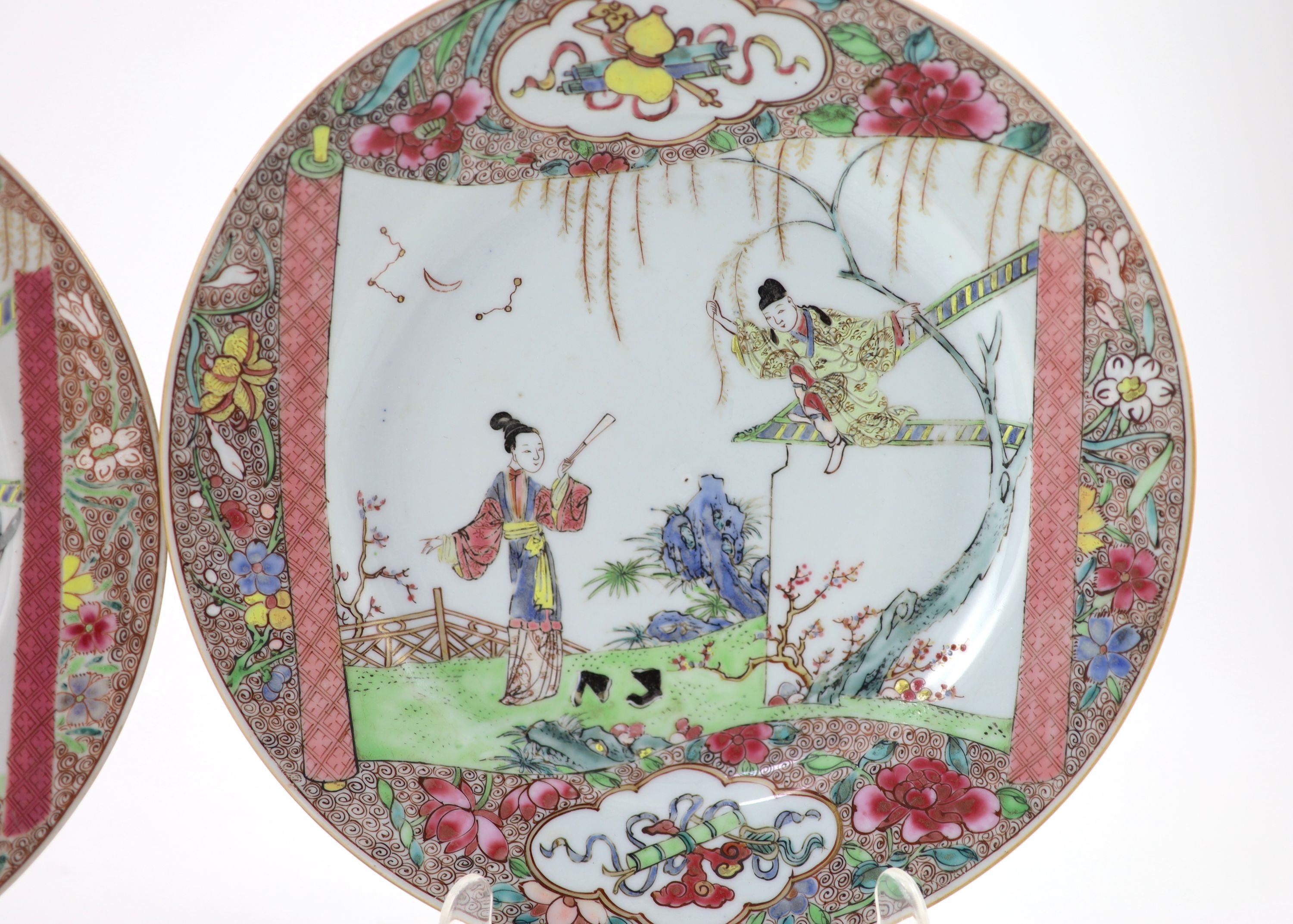 A near pair of Chinese famille rose plates, early Qianlong period, 23.3 and 22.7cm diameter